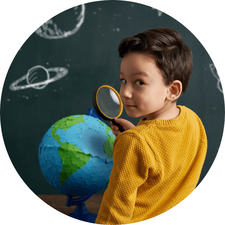 The image is cropped in a circle and shows a young child looking at a globe through a magnifying glass.