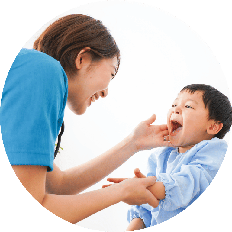 Image is cropped to a circle and shows a woman touching a small child's face who is laughing