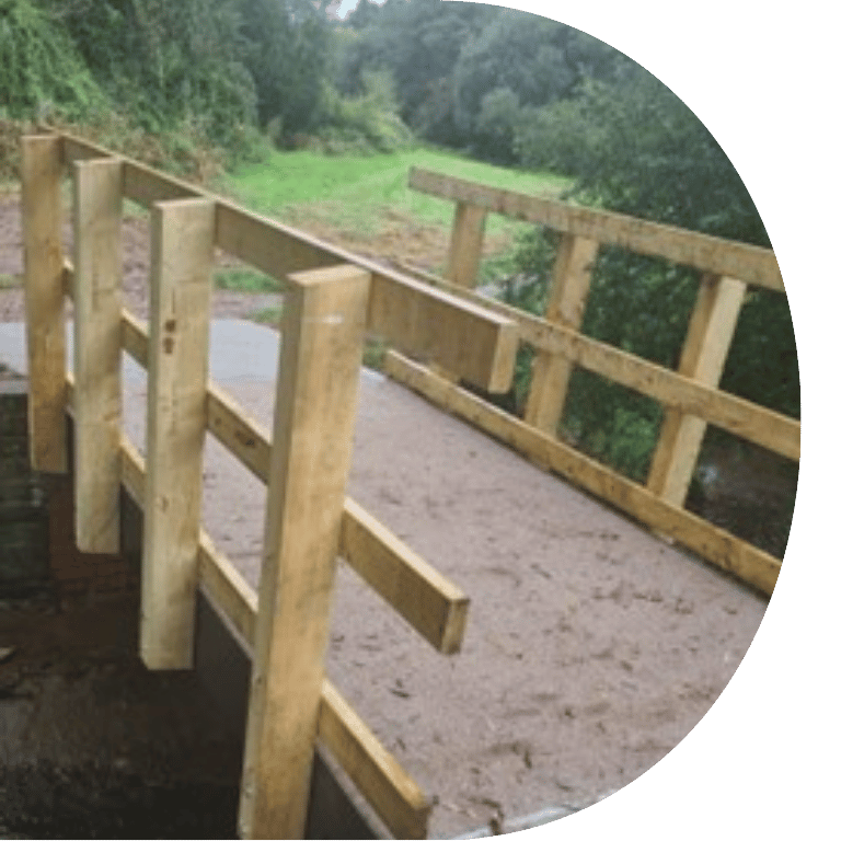 Image is cropped to a D shape and shows Stoke Meadow Close footbridge