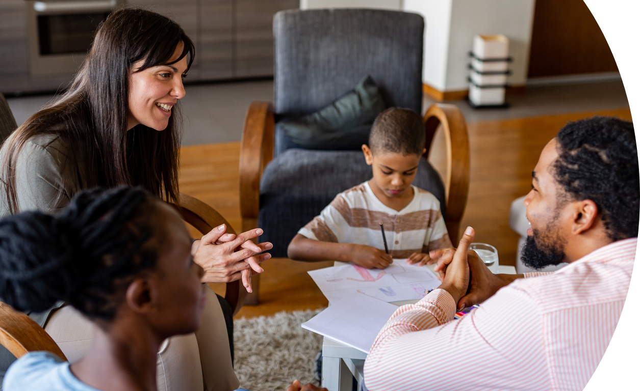 family and social worker sat in a lounge talking