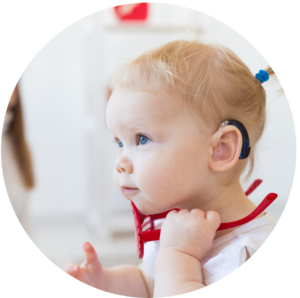 Picture of a young child wearing a hearing aid.
