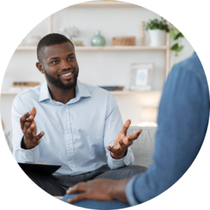 Image shows a person smiling and gesturing to someone sat just out of frame
