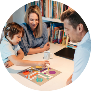Family with a young deaf child playing a board game