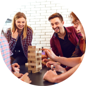 A group of young adults playing Jenga