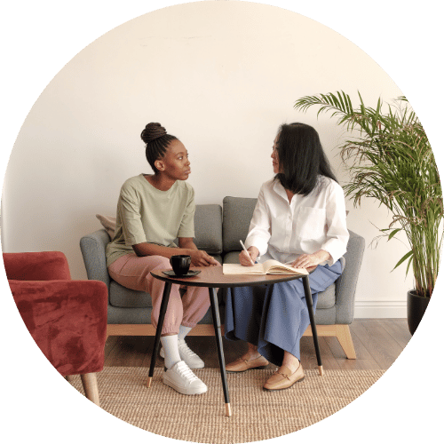 Two people having a discussion sat facing each other.