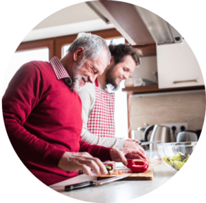 Two adults preparing food together.