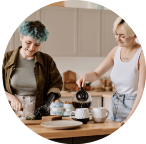 Two young adults making hot drinks together. One of them has a prosthetic arm