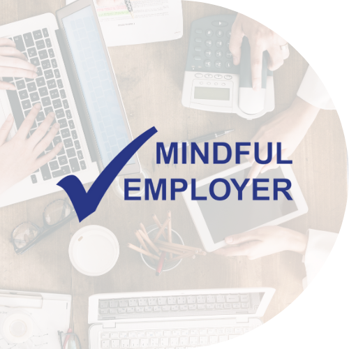 image of people working on laptops, with the mindful employer logo on top of the image