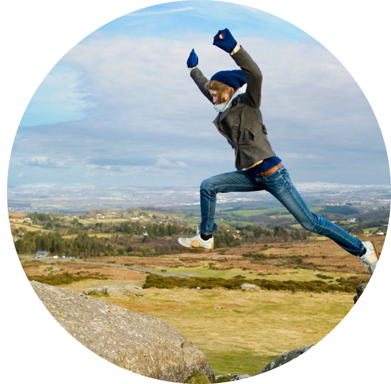 Woman Jumping Between Rocks stock photo